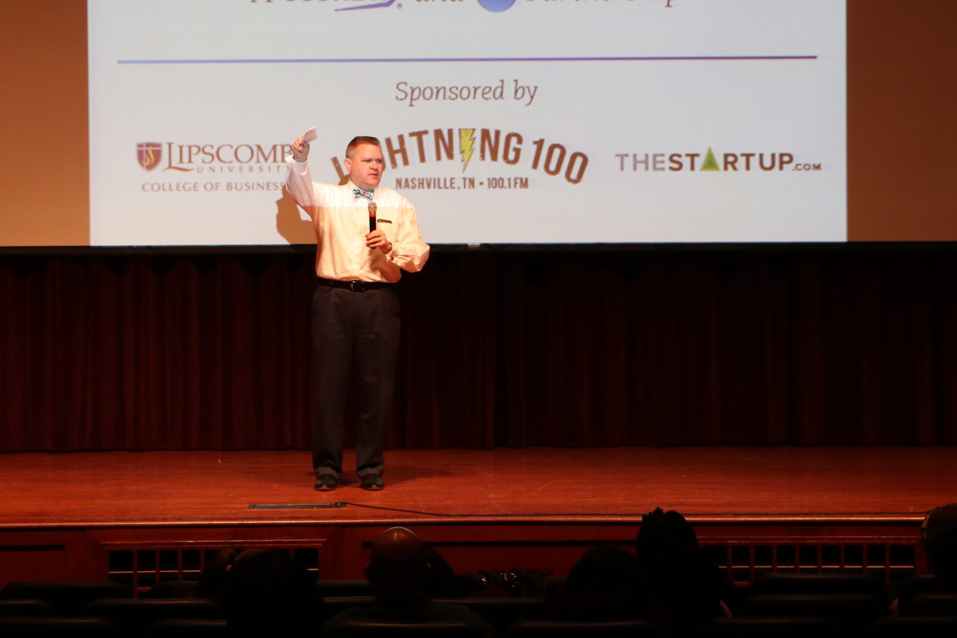 Richard Pickett speaking on stage to an audience